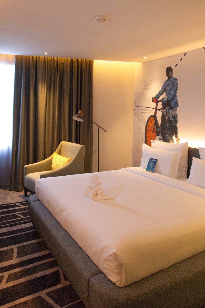 Modern hotel room interior in South Jakarta, offering cozy ambiance with warm lighting and stylish decor.